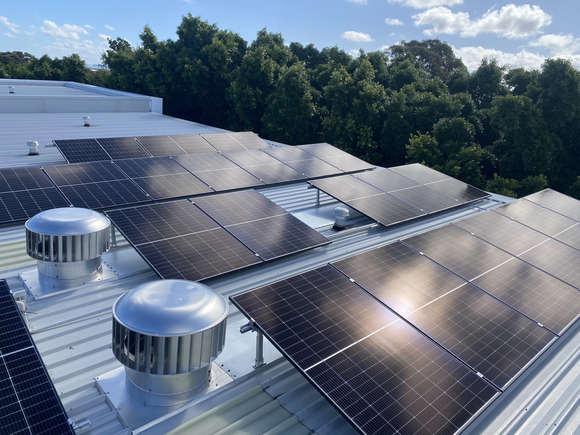 Fresh rooftop solar panel installation on a metal roof