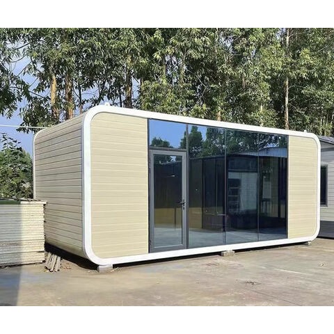 Modular home unit with beige cladding and full-height glass entrance