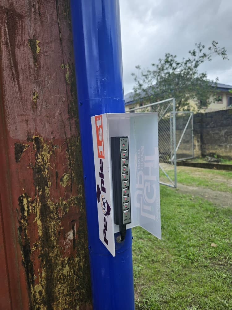 Outdoor community solar USB charging station on blue pole